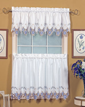 Blue and white Verona Embroidered Cutwork Kitchen Valance and Tier Curtains hanging on a curtain rod